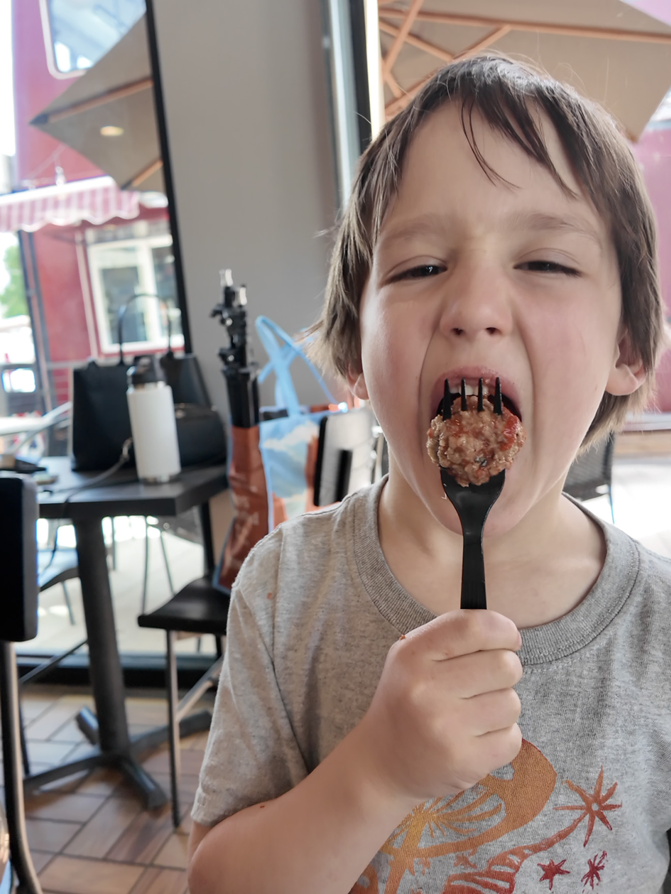 Kid eating meatball